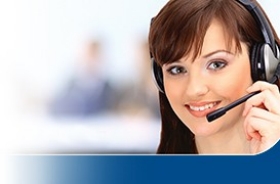 Customer service representative wearing a headset and smiling, with a blurred office background Customer service representative wearing a headset and smiling, with a blurred office background